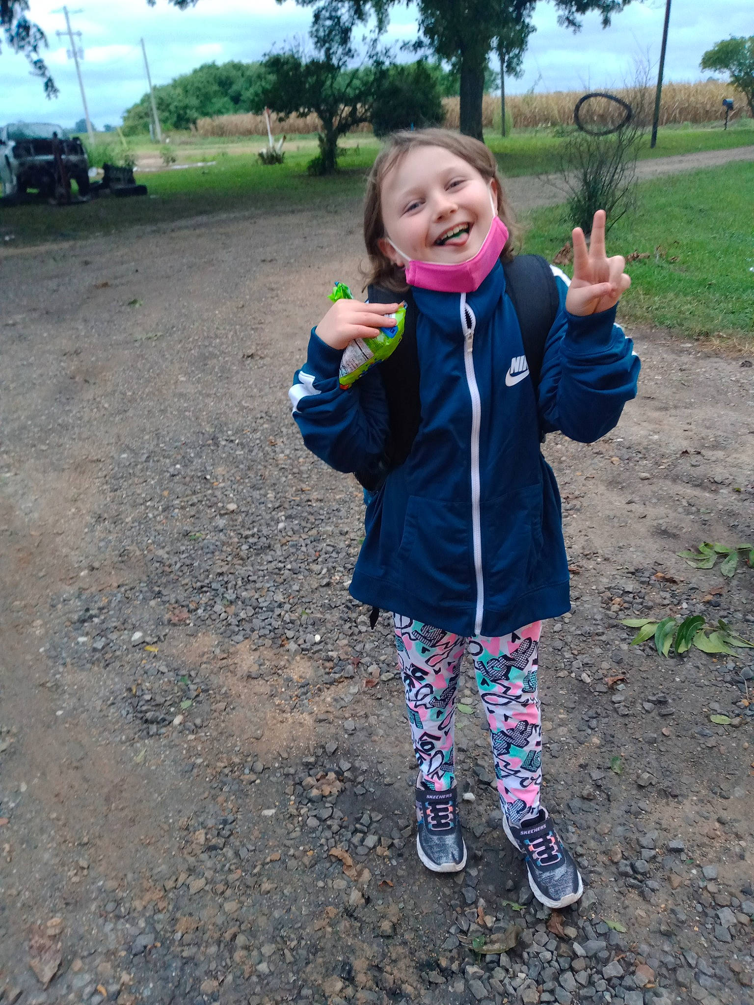 Kylie is registered to the contest to win money with this photo: asphalt, baby_toddler_clothing, electric_blue, face, fun, gesture, grass, happy, head, joy, leisure, people_in_nature, person, plant, recreation, sky, sleeve, smile, sneakers, soil