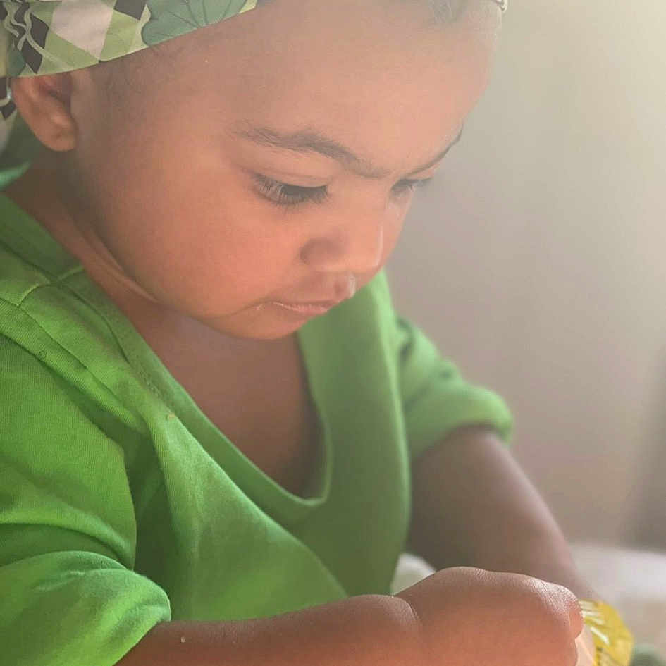Kaylynn is registered to the contest to win money with this photo: arm, baby, baby_toddler_clothing, cap, cheek, child, chin, comfort, eyebrow, fashion_accessory, fun, happy, headgear, lip, mouth, nose, skin, sun_hat, toddler, tummy_time