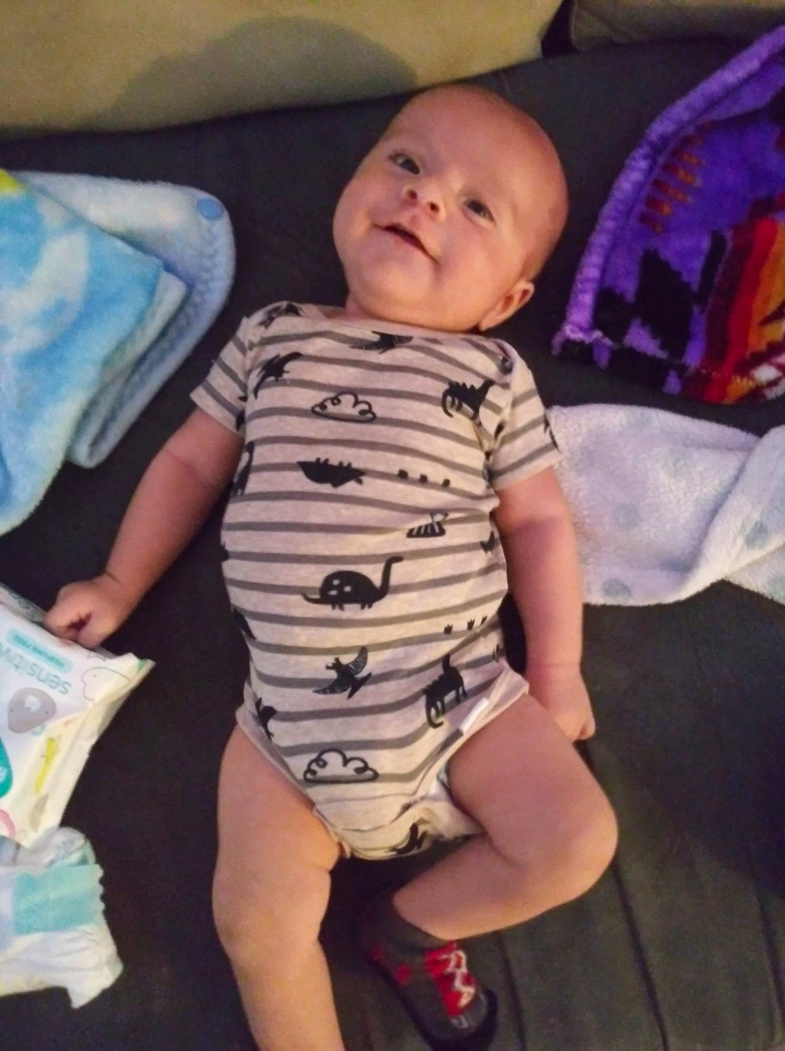 Christopher is registered to the contest to win money with this photo: arm, baby, cheek, child, diaper, face, facial_expression, fun, head, leg, nose, person, play, sitting, skin, smile, toddler