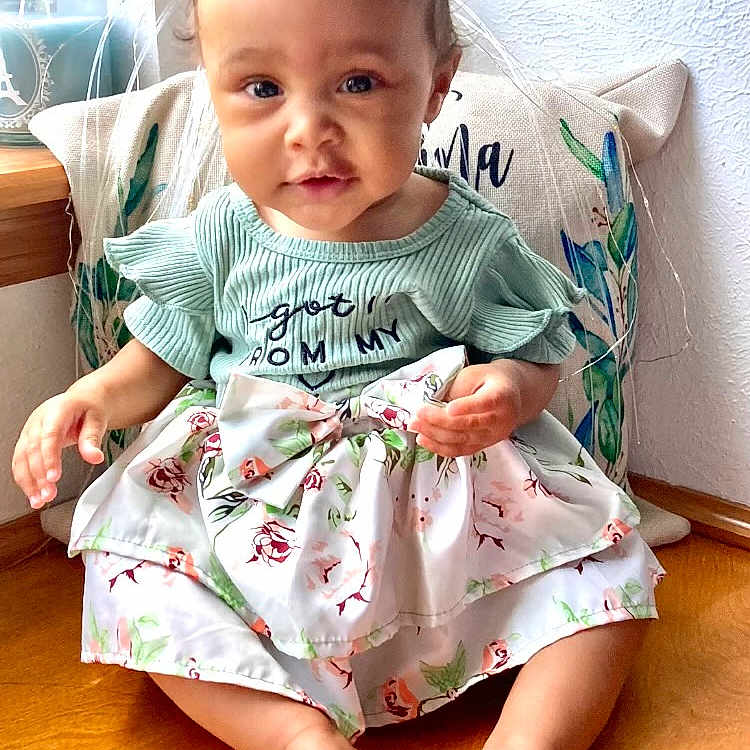 Sierra joined the competition — help win amazing prizes! baby, bodypart, clothing, cushion, dress, face, finger, furniture, hand, happy, hardwood, head, homedecor, person, photography, portrait, sitting, sleeve, smile, wood