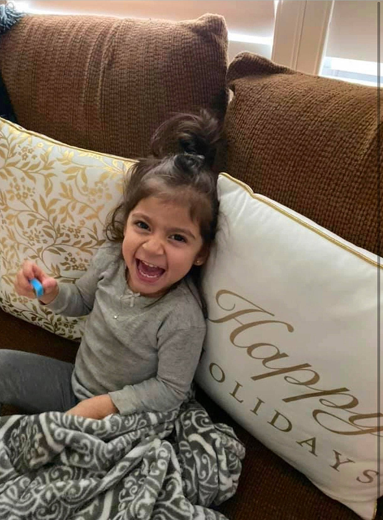 Aria joined the competition — help win amazing prizes! child, comfort, couch, floor, flooring, furniture, hair, happy, linens, living_room, mammal, morning, pattern, person, pillow, smile, textile, throw_pillow, toddler, tree