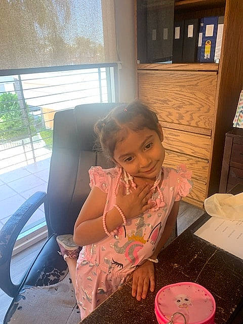 Aria joined the competition — help win amazing prizes! chair, child, comfort, cooking, curtain, dishware, dress, fun, joy, leisure, person, plant, plate, platter, room, sitting, smile, table, tableware, toddler