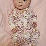 Leah is registered to the contest to win money with this photo: baby, infant, onesie, floral_pattern, pink_blanket, lying_down, cute, child, sleepwear, soft_texture, portrait, young, small_hands, small_feet, indoors, cozy, peaceful, calm, face, expression