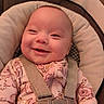 baby, smile, infant, baby_seat, safety_harness, onesie, floral_pattern, happy, face, child, straps, cushion, comfort, indoor, closeup, head, person, cute, expression, seat