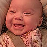 baby, smiling, face, closeup, infant, child, pink_clothing, car_seat, seatbelt, happy, cute, cheeks, portrait, young_child, indoors, clothing, person, head, expression, warm_lighting
