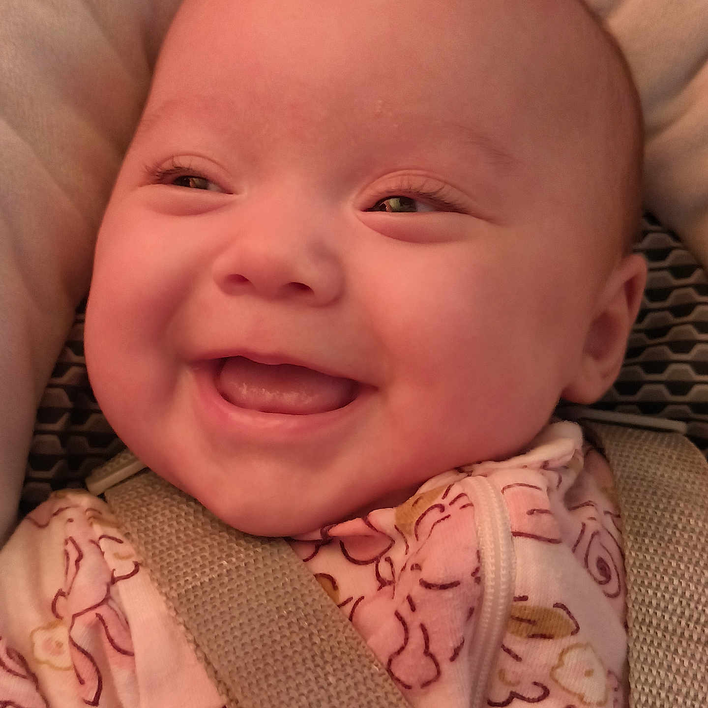 Leah is registered to the contest to win money with this photo: baby, smiling, face, closeup, infant, child, pink_clothing, car_seat, seatbelt, happy, cute, cheeks, portrait, young_child, indoors, clothing, person, head, expression, warm_lighting