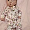 Leah is registered to the contest to win money with this photo: baby, infant, onesie, floral_pattern, blanket, pink, lying_down, face, head, hands, feet, sleepwear, soft_texture, cute, child, newborn, portrait, calm, indoors, resting