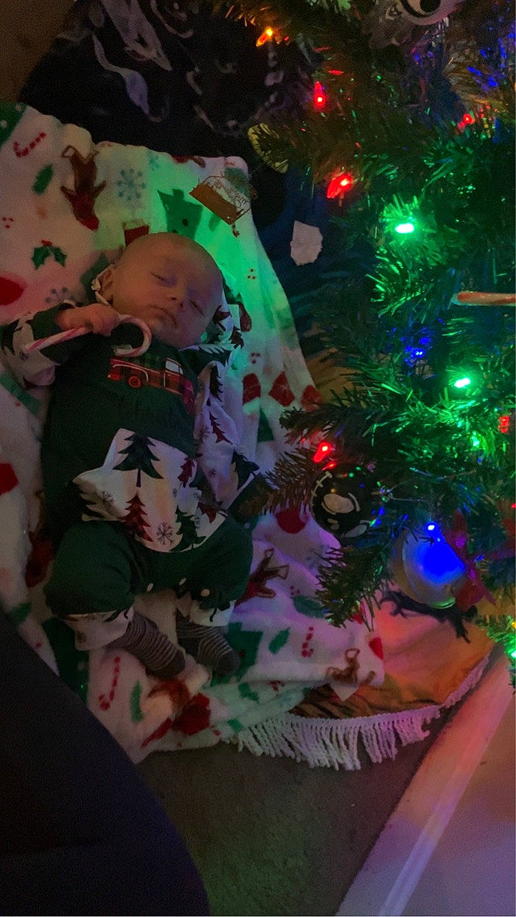 Brandon is registered to the contest to win money with this photo: baby, christmas, christmas_decoration, christmas_eve, christmas_ornament, christmas_tree, conifer, design, electric_blue, event, evergreen, fun, holiday, holiday_ornament, leaf, ornament, person, plant, toddler, tree