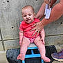 Rosaline joined the competition — help win amazing prizes! baby, child, person, hands, shirt, concrete_wall, chair, footwear, blue_chair, expression, support, outdoor, concrete_floor, baby_clothing, pink_shorts, barefoot, adult_hands, seated, small_chair, casual