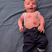 Richard joined the competition — help win amazing prizes! arms, baby, bare_chest, blue_blanket, cute, expression, face, feet, hands, indoor, infant, kiss_marks, lipstick_marks, lying_down, navy_pants, plaid_cuffs, portrait, skin, smiling, suspenders