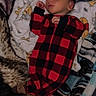 baby, sleeping, infant, onesie, red_and_black, checkered, blanket, soft, cozy, peaceful, cute, child, rest, indoor, portrait, young, person, comfort, nap, warm