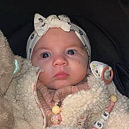 Louise participe au concours pour gagner de l'argent avec cette photo : baby, beads, blanket, bundle, child, clothing, cozy, cute, expression, face, fur, headband, indoors, infant, newborn, pacifier, person, portrait, soft, warm