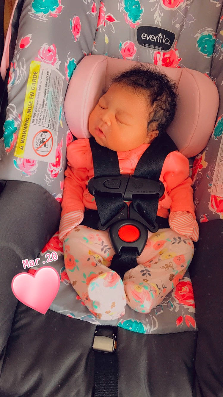 Rihanna is registered to the contest to win money with this photo: baby, baby_carriage, baby_in_car_seat, baby_products, baby_sleeping, baby_toddler_clothing, car_seat, carmine, child, comfort, head, human_leg, lap, mouth, person, pink, sitting, skin, sock, thigh