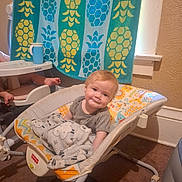 Sharon joined the competition — help win amazing prizes! baby, infant, child, smiling, portrait, sitting, bouncer, baby_gear, blanket, plush, towel, pineapple, bathroom, indoors, home, carpet, furniture, colorful, happy, face