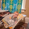 baby, infant, child, smiling, portrait, sitting, bouncer, baby_gear, blanket, plush, towel, pineapple, bathroom, indoors, home, carpet, furniture, colorful, happy, face