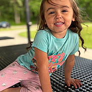Everleigh joined the competition — help win amazing prizes! bracelet, casual, child, clothing, cute, daylight, face, greenery, hair, happy, leggings, metal, nature, outdoor, park, person, playful, sitting, smiling, table