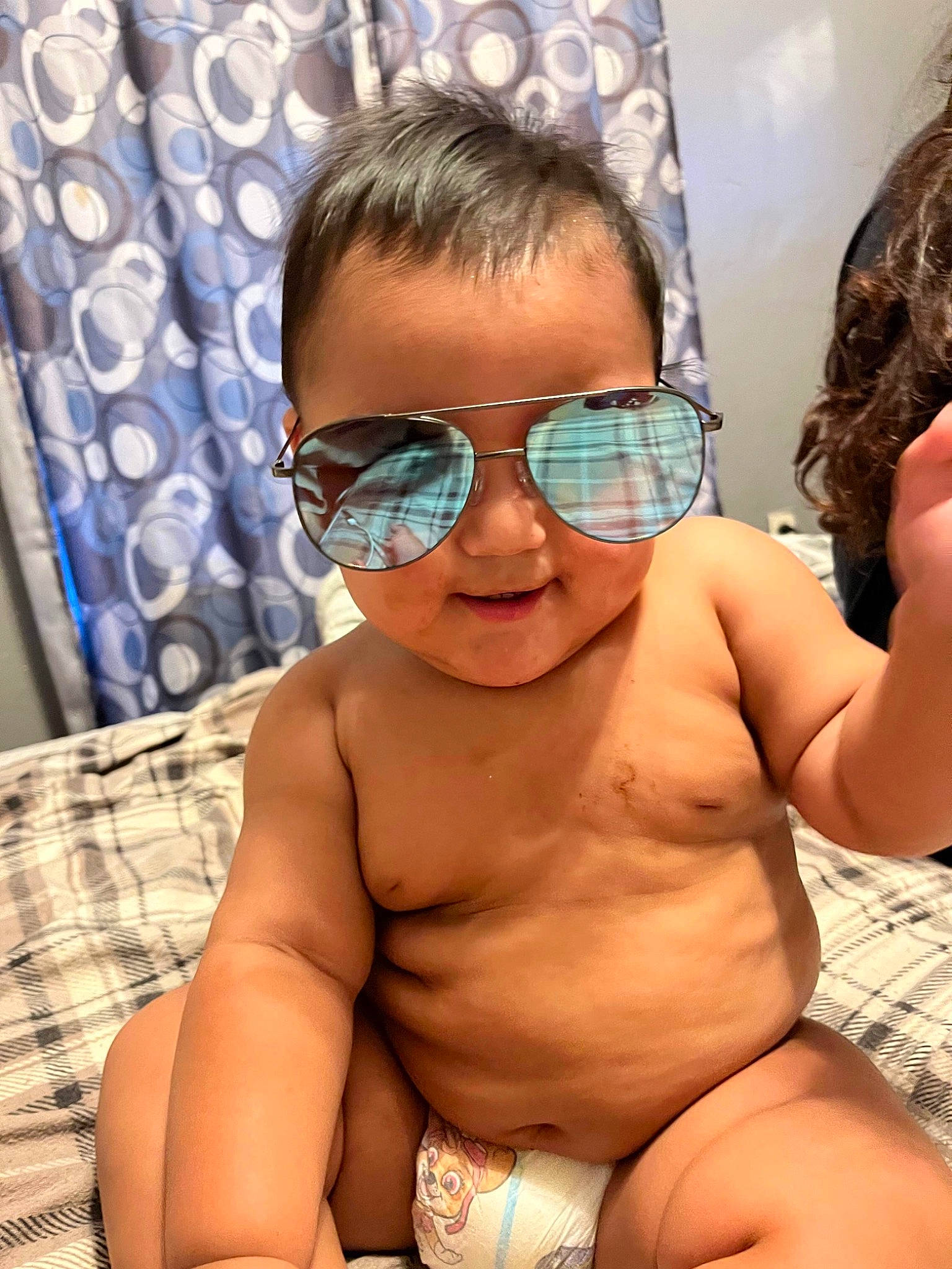 Tavion is registered to the contest to win money with this photo: black_hair, chest, chin, cool, eyewear, fun, glasses, goggles, hair, happy, mouth, muscle, neck, person, shoulder, skin, smile, sunglasses, toddler, trunk