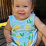 baby, child, smile, sitting, dress, lemon_pattern, wooden_floor, happy, cute, toddler, face, skin, arm, leg, daylight, outdoor, infant, person, clothing, nature