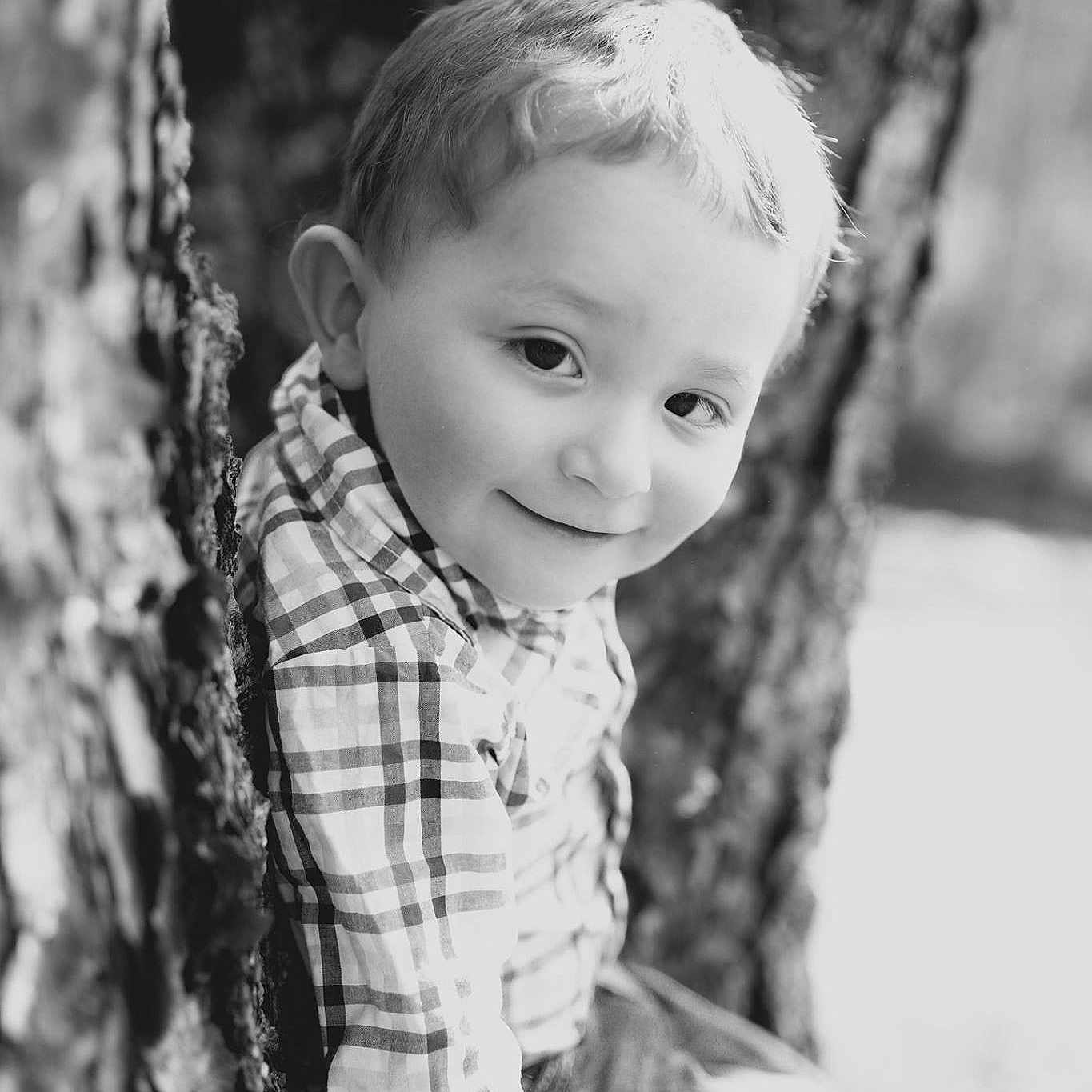 Trenton is registered to the contest to win money with this photo: black, black_and_white, child, child_model, eye, face, iris, male, monochrome, monochrome_photography, people, person, photograph, photography, plant, portrait, portrait_photography, standing, toddler, tree