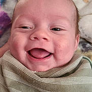 Bryar joined the competition — help win amazing prizes! baby, smiling, face, blanket, infant, happy, wrapped, closeup, cute, child, head, skin, expression, comfort, soft, portrait, indoors, person, newborn, cozy