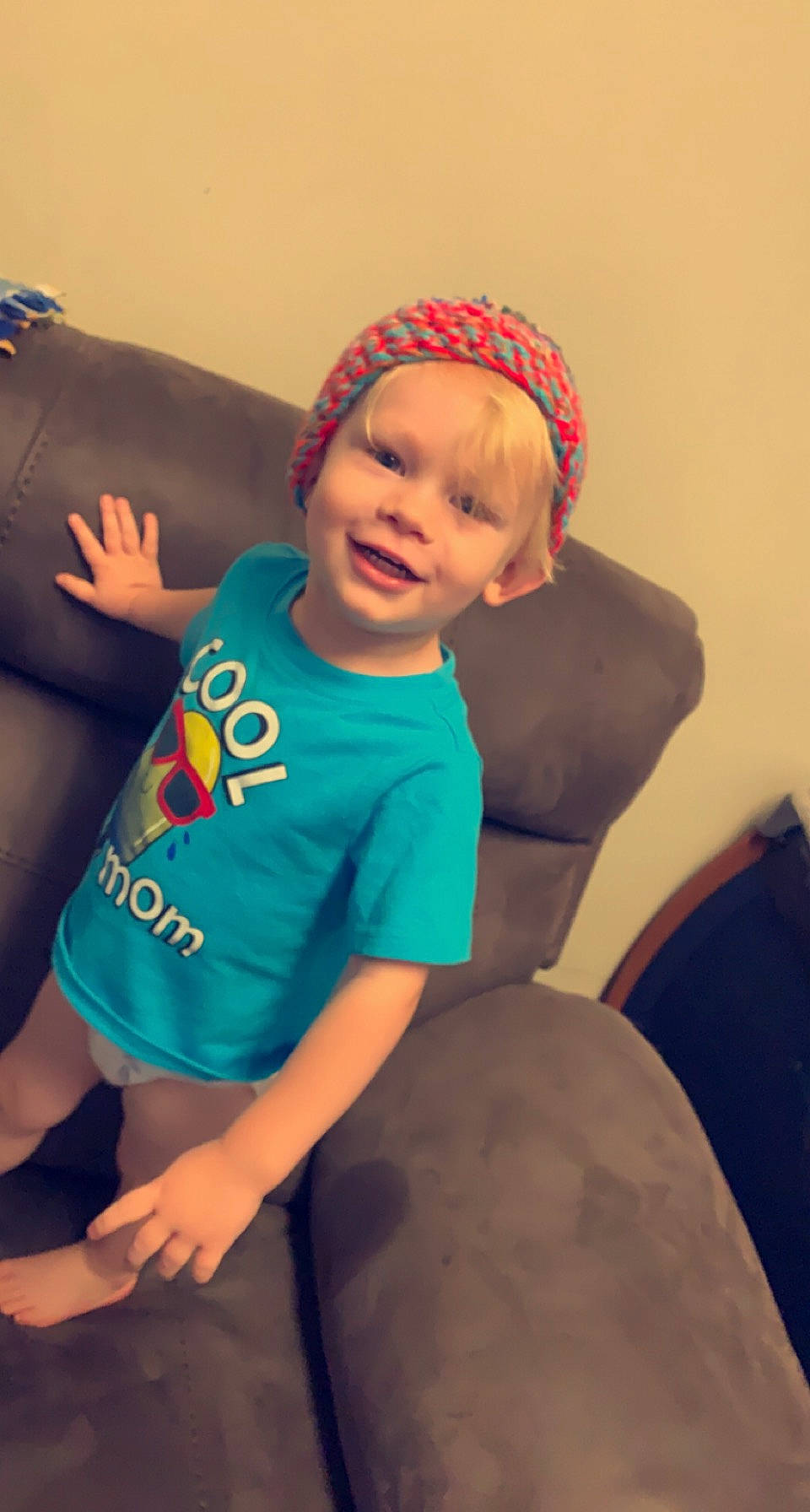 Aron is registered to the contest to win money with this photo: arm, baby, baby_toddler_clothing, cap, comfort, eye, face, finger, fun, happy, head, human_body, joy, lap, leg, mouth, person, smile, t_shirt, thigh