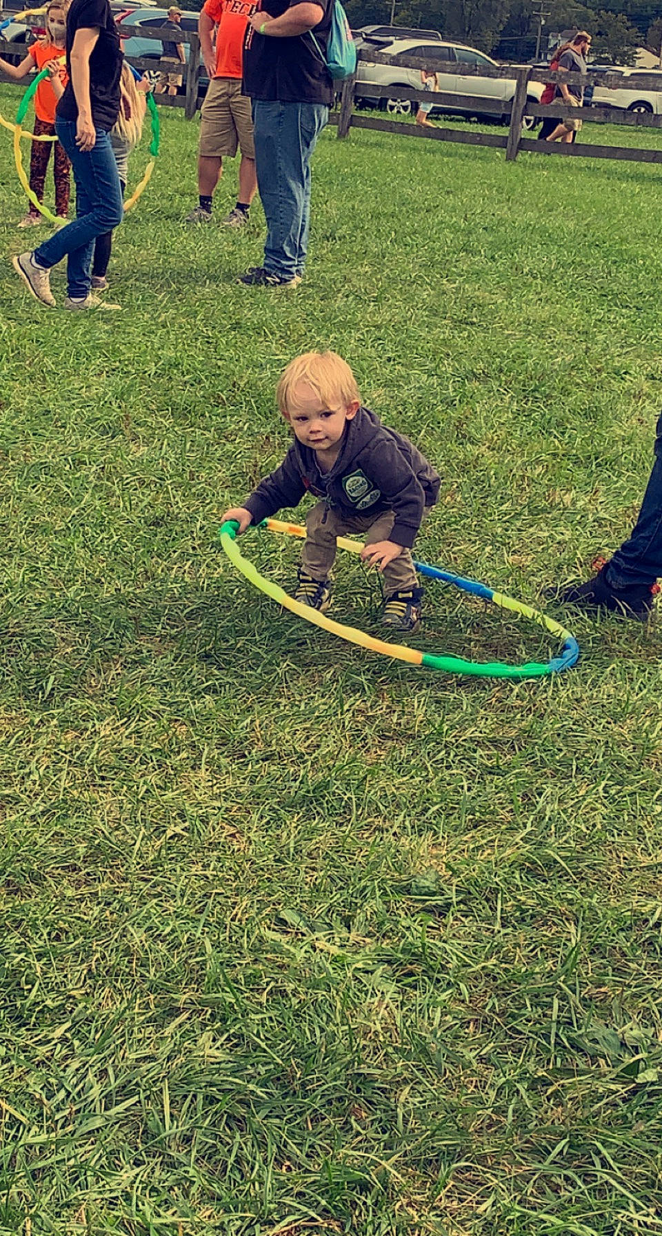 Aron is registered to the contest to win money with this photo: baby, event, fun, garden, grass, grass_family, grassland, hose, hula_hoop, lawn, leisure, outdoor_play_equipment, people_in_nature, person, plant, recreation, sneakers, soil, toddler, toy