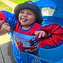 Amari is registered to the contest to win money with this photo: toddler, child, baby, smiling, playful, outdoor, pool, floatation_vest, spiderman, hat, sunlight, backyard, blue, red, hand_holding, tongue_out, person, summer, fun, water_toy
