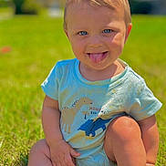 Amari joined the competition — help win amazing prizes! child, toddler, blue_eyes, tongue_out, onesie, dinosaur_print, grass, outdoor, sunny_day, smiling, cute, baby, sitting, playful, innocence, portrait, greenery, summer, childhood, happy