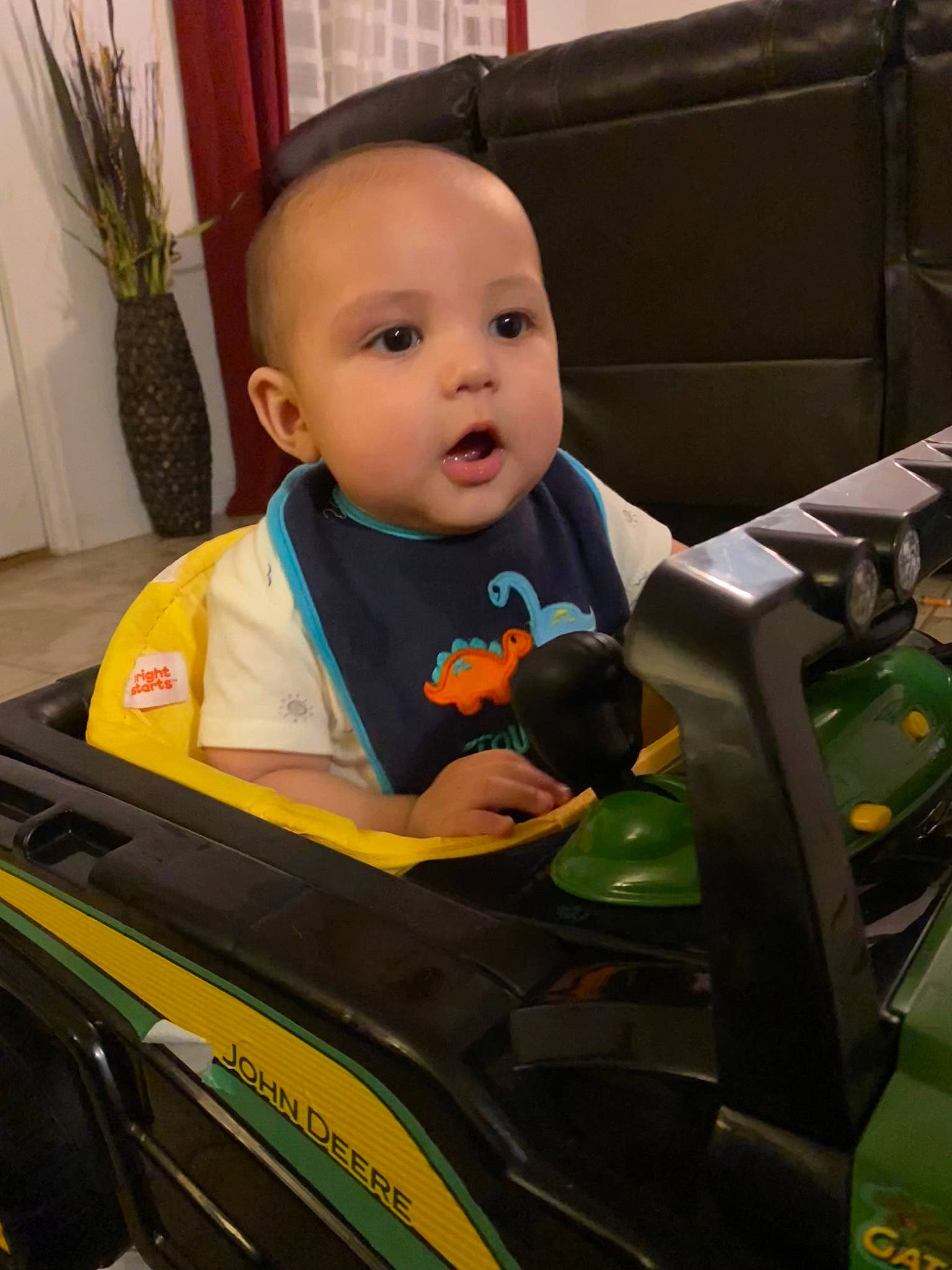 Damian is registered to the contest to win money with this photo: automotive_design, automotive_exterior, automotive_lighting, baby, baby_toddler_clothing, child, electronic_device, fun, houseplant, motor_vehicle, outerwear, person, plant, product, sitting, standing, technology, tire, toddler, vehicle