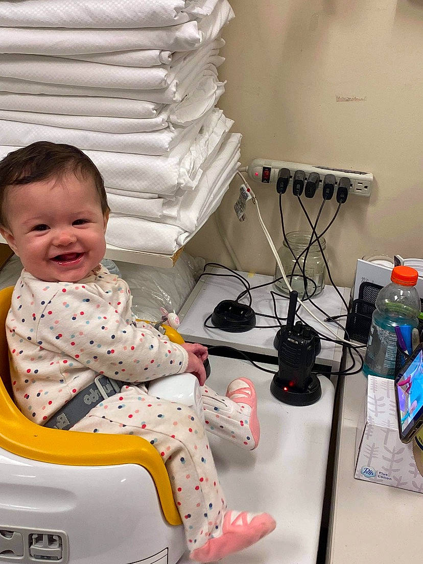 Marilynn is registered to the contest to win money with this photo: audio_equipment, baby, baby_carriage, baby_products, baby_toddler_clothing, cable, child, comfort, electrical_wiring, electronic_engineering, gadget, happy, input_device, joy, lamp, person, room, sitting, smile, technology