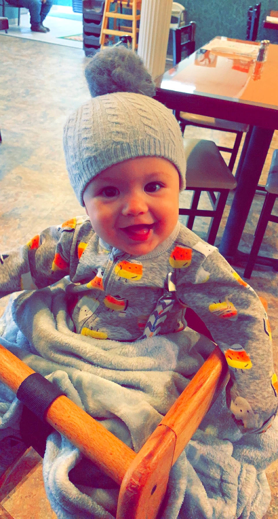 Marilynn joined the competition — help win amazing prizes! baby, baby_toddler_clothing, beanie, cap, chair, cheek, child, fun, happy, headgear, headwear, joy, knit_cap, person, personal_protective_equipment, photograph, sitting, skin, smile, table