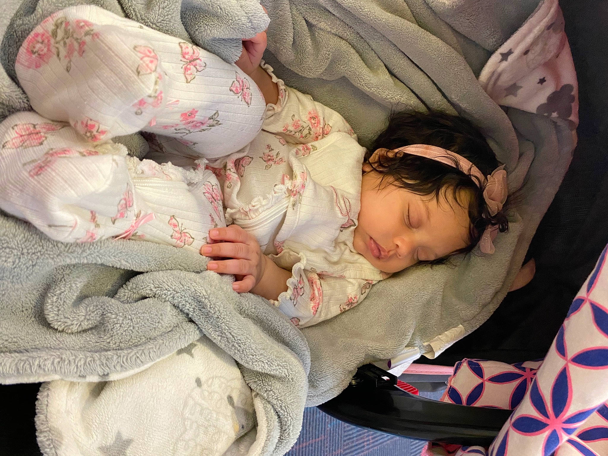 Layla is registered to the contest to win money with this photo: arm, baby, baby_carriage, baby_products, baby_sleeping, baby_toddler_clothing, bedding, bedtime, carmine, child, comfort, hand, head, linens, mammal, nap, pattern, person, product, sitting