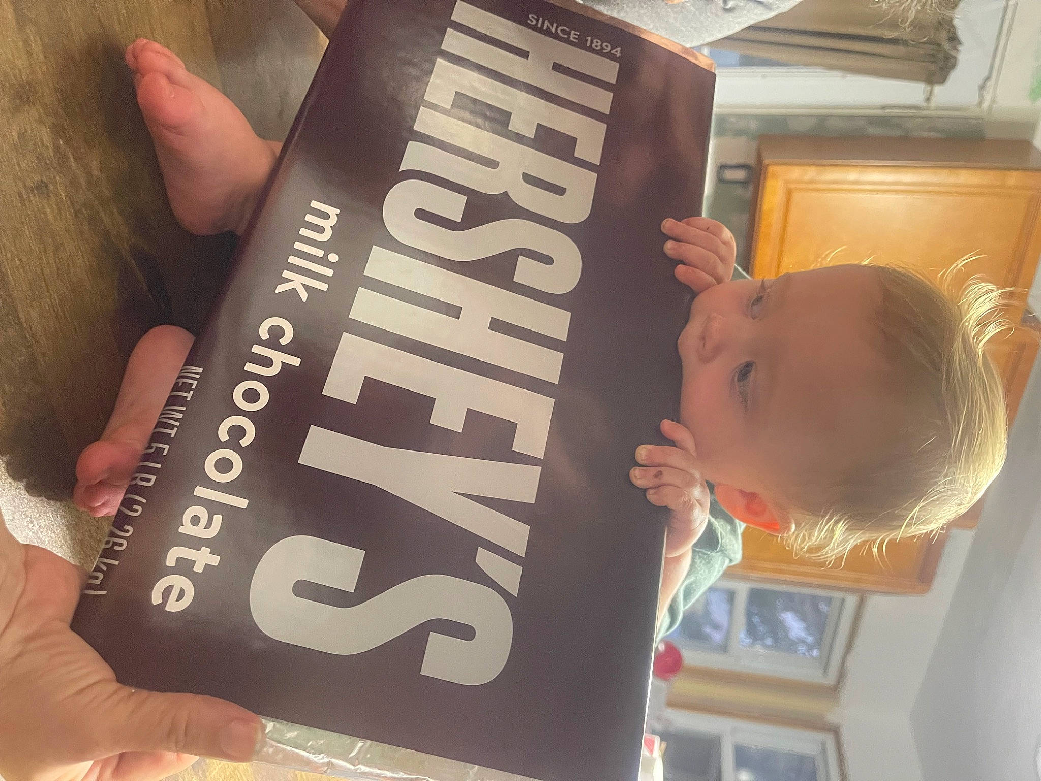 Lane is registered to the contest to win money with this photo: advertising, baby, book, book_cover, brand, finger, font, hand, nail, person, publication, reading, thumb, toddler, wood