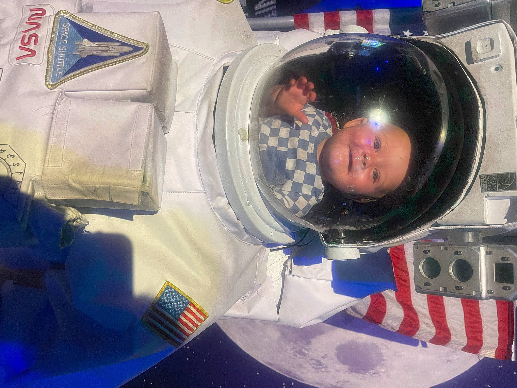 Lane is registered to the contest to win money with this photo: astronaut, audio_equipment, auto_part, automotive_design, automotive_lighting, automotive_tire, automotive_wheel_system, electric_blue, electronic_device, engineering, fun, gas, hearing, helmet, machine, motor_vehicle, person, personal_protective_equipment, plastic, smile