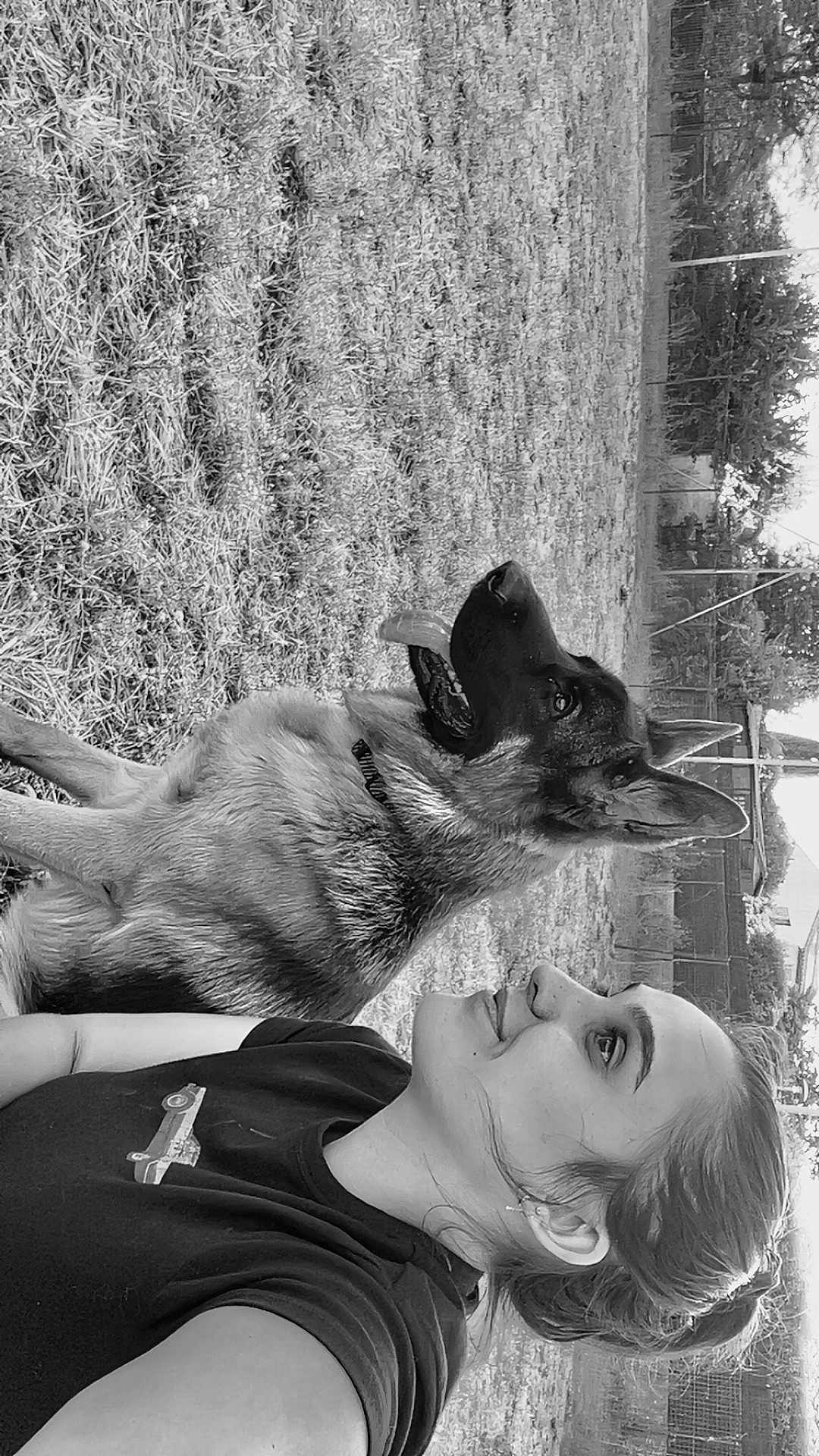Vyper participe au concours pour gagner de l'argent avec cette photo : woman, dog, german_shepherd, outdoor, grass, pet, animal, companion, nature, portrait, black_and_white, relaxing, side_view, casual_clothing, fence, trees, daytime, friendship, animal_portrait, smile