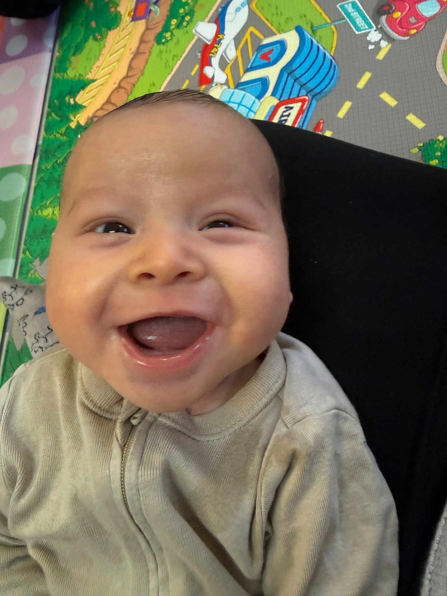 Brayden joined the competition — help win amazing prizes! baby, smiling, infant, face, closeup, joyful, open_mouth, tongue, eyes, cheeks, onesie, romper, playmat, colorful_background, toy, nursery, portrait, happy, baby_play, child