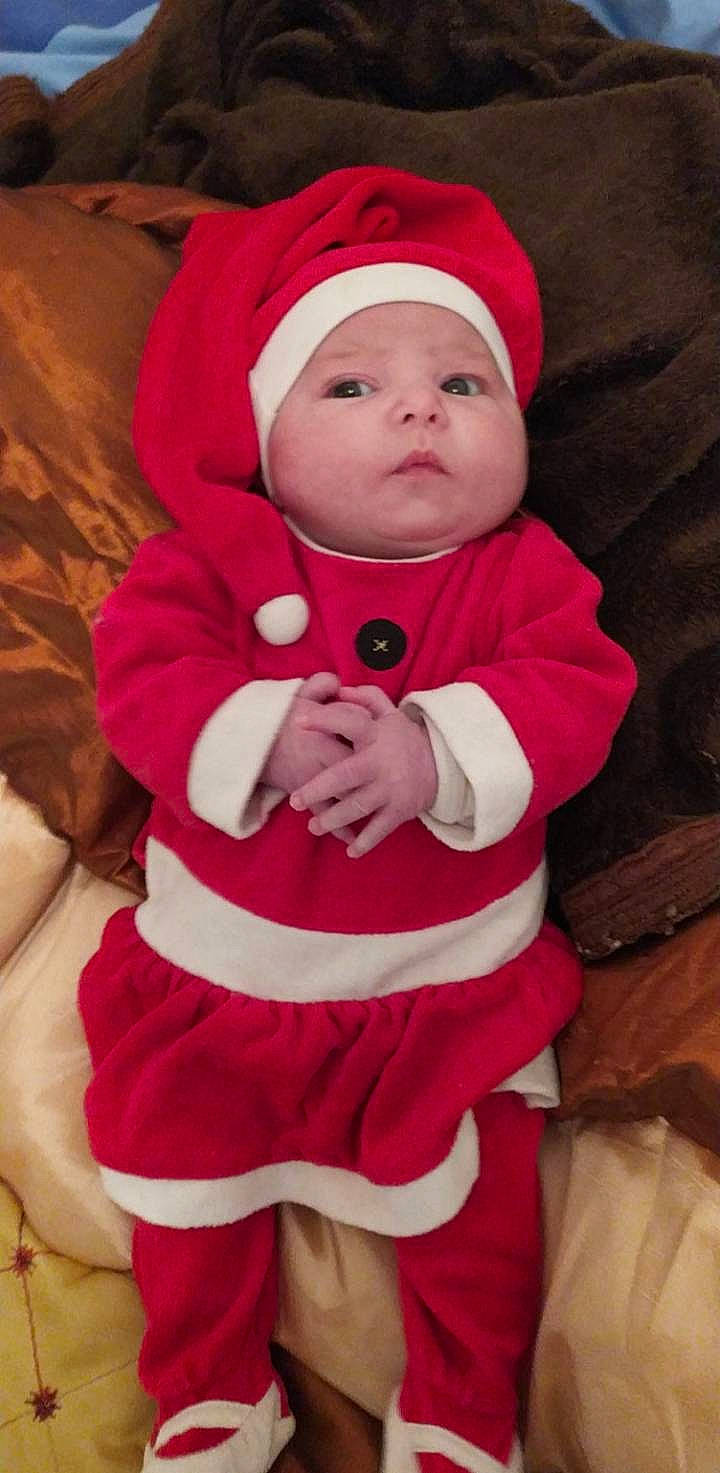 Emma participe au concours pour gagner de l'argent avec cette photo : baby, child, christmas, christmas_eve, fictional_character, headwear, person, red, santa_claus, toddler