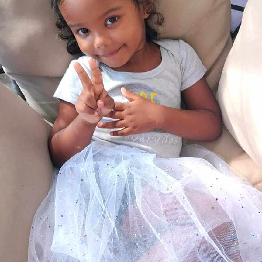 Indyra participe au concours pour gagner de l'argent avec cette photo : casual, cat_ears, chair, child, cushion, cute, fashion, girl, happy, headband, indoor, peace_sign, person, playful, portrait, sitting, skirt, smile, sneakers, tutu