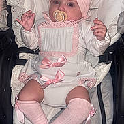 Aurora-Rose is registered to the contest to win money with this photo: baby, infant, pacifier, headband, bow, pink, white, socks, stroller, cushion, clothing, cute, child, portrait, indoor, newborn, lying_down, adorable, baby_girl, soft