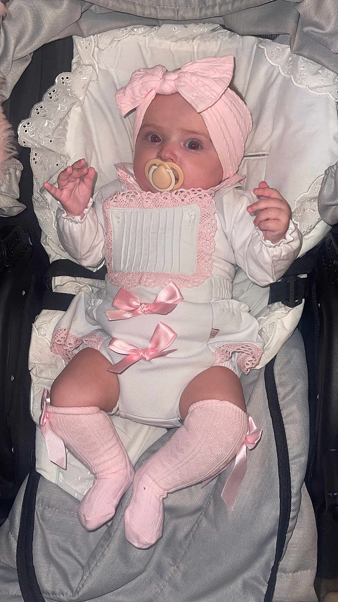 Aurora-Rose is registered to the contest to win money with this photo: baby, infant, pacifier, headband, bow, pink, white, socks, stroller, cushion, clothing, cute, child, portrait, indoor, newborn, lying_down, adorable, baby_girl, soft