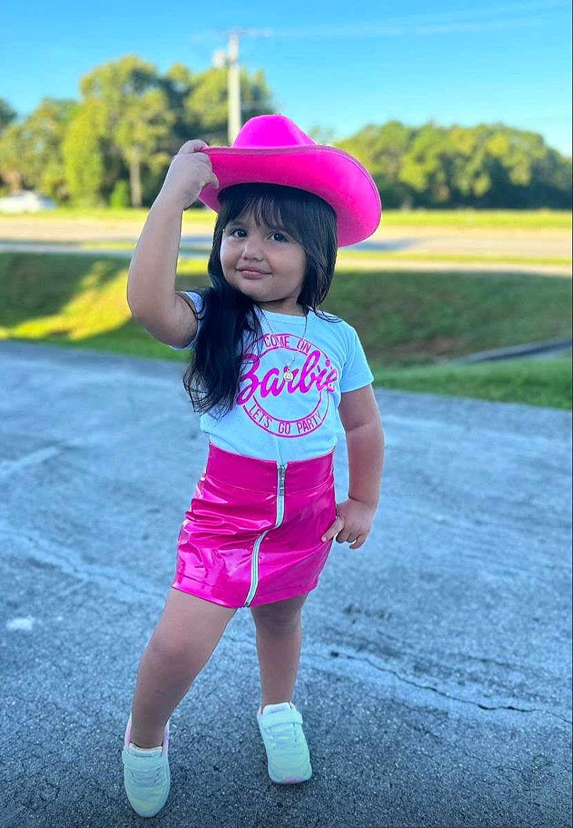 Dulce Maria is registered to the contest to win money with this photo: blackhair, child, clothing, face, female, girl, hair, happy, hat, head, person, racket, shorts, sleeve, smile, sombrero, sport, standing, tennis, tennisracket