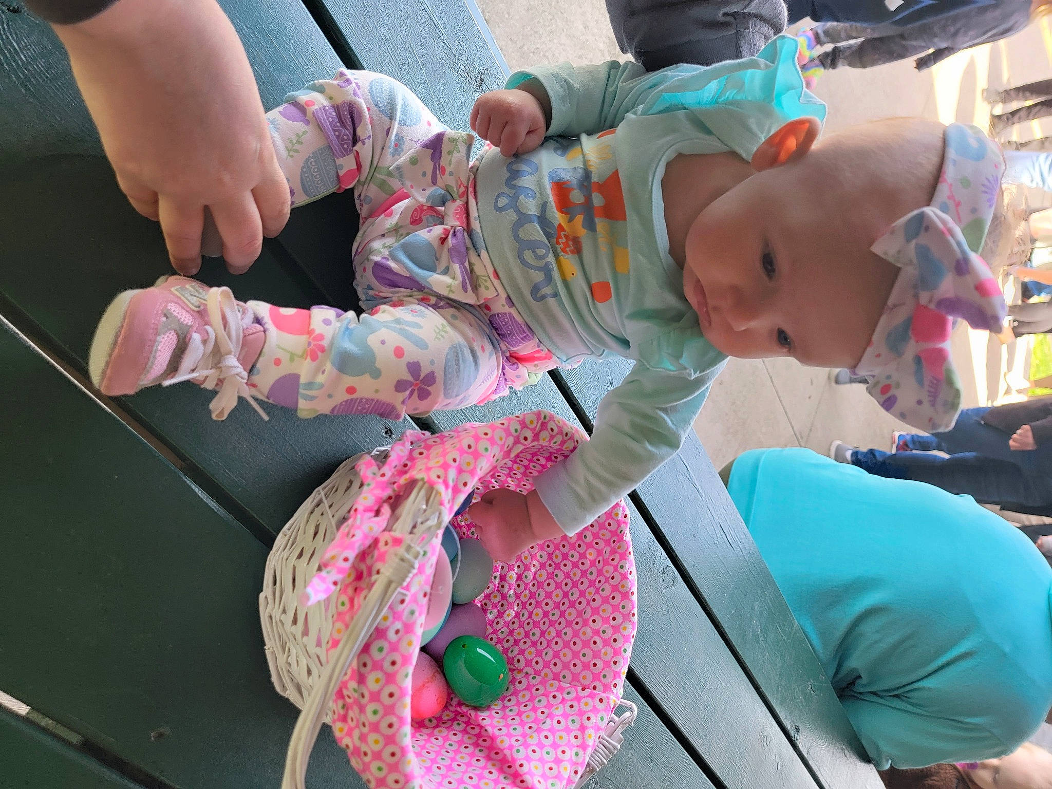 Raelynn is registered to the contest to win money with this photo: baby, baby_products, baby_toddler_clothing, child, foot, fun, gesture, green, human_leg, leisure, people, person, pink, recreation, sitting, sock, thigh, thumb, toddler, tree