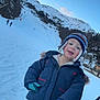 Timéo a rejoint le concours — aidez-le/la à gagner de superbes lots ! child, winter_clothing, snow, mountain, blue_sky, hat, gloves, jacket, pants, outdoor, smiling, cold_weather, nature, recreation, playful, happy, person, scenic, daytime, holiday