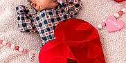 Kash joined the competition — help win amazing prizes! baby, infant, onesie, heart_pattern, red_heart, love_balloon, pink_background, blanket, cute, valentines_day, sleepy, soft_texture, adorable, newborn, lying_down, celebration, holiday, decorations, heart_shaped, cozy