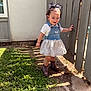 child, toddler, outdoor, grass, fence, denim, dress, boots, curly_hair, sunlight, shadow, exploring, happy, person, nature, wood, playful, young, smiling, daylight