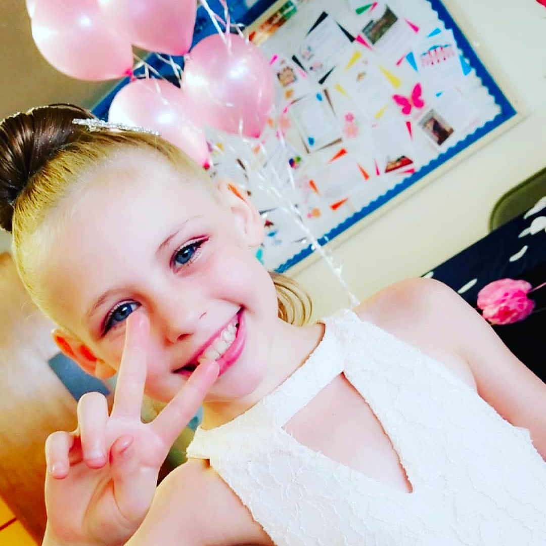 Nevaeh joined the competition — help win amazing prizes! beauty, child, ear, eyelash, finger, girl, hair_accessory, hand, happiness, joy, person, petal, pink, product, skin, smile