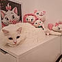 cat, white_cat, blue_eyes, plush_toys, stuffed_animals, cabinet, indoor, decor, feline, cute, cozy, collection, portrait, animal, pet, resting, soft, pink, white, home