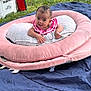 Cattaleya is registered to the contest to win money with this photo: baby, infant, outdoor, grass, cushion, pink, pillow, blanket, cooler, toy, person, cute, face, head, smile, nature, relaxing, sunlight, playtime, child