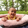 Cattaleya joined the competition — help win amazing prizes! baby, child, smile, yellow_clothing, pink_cushion, outdoor, grass, trees, nature, happy, infant, playful, face, portrait, summer, blanket, cute, relaxing, sunlight, park
