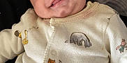 Kingsley is registered to the contest to win money with this photo: baby, bodypart, clothing, cushion, face, finger, furniture, hand, happy, head, homedecor, knitwear, newborn, pajamas, pants, person, photography, portrait, smile, sweater
